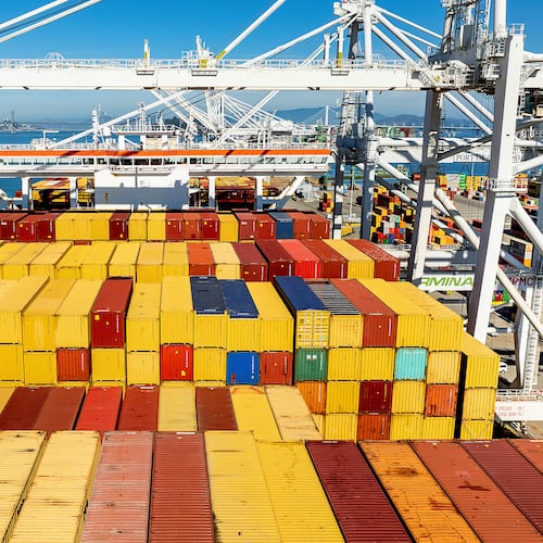 FILE - Cargo containers line a ship at the Port of Oakland on Wednesday, Aug. 6, 2025, in Oakland, Calif. (AP Photo/Noah Berger, File)