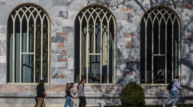 Students at Emory University stroll by Convocation Hall on the quad Tuesday, Dec. 17, 2024. The school is among more than 40 universities being investigated by the Department of Education for alleged Title VI violations. (AJC File)