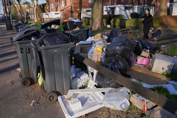 Rubbish piles up on a residential street in Birmingham, England, Monday, April 7, 2025, amid an ongoing refuse workers' strike in the city. (AP Photo/Kirsty Wigglesworth)