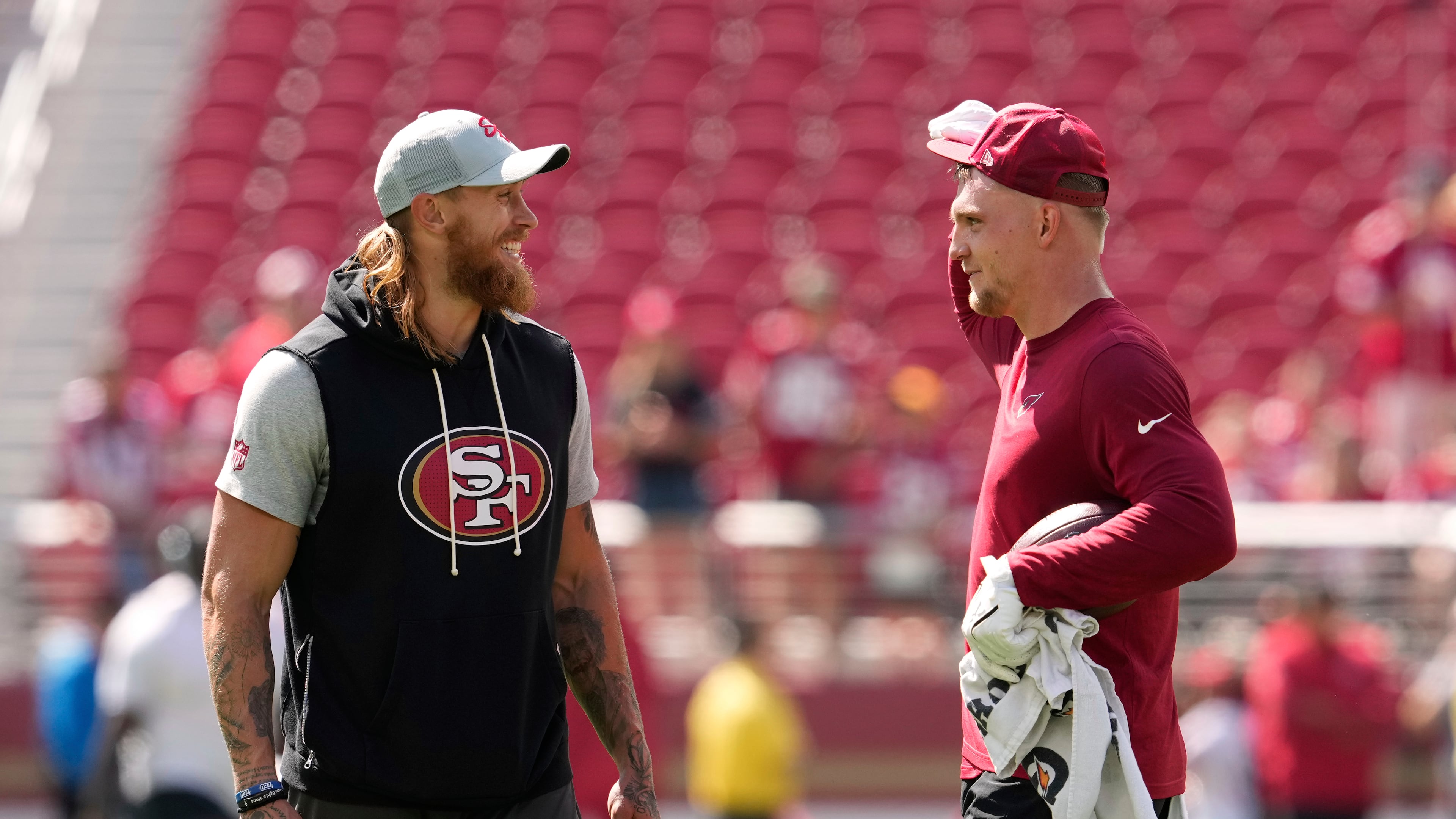 San Francisco 49ers tight end George Kittle, left, and Arizona Cardinals tight end Trey McBride chat prior to an NFL football game Sunday, Sept. 21, 2025, in Santa Clara. (AP Photo/Godofredo A. Vásquez)