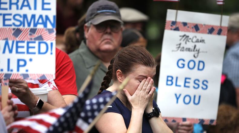 A woman wipes away tears after a Sept. 1, 2018, wreath-laying ceremony to honor the late Sen. John McCain, R-Ariz., at the Vietnam Veterans Memorial on the National Mall in Washington, D.C. (Chip Somodevilla/Getty Images)