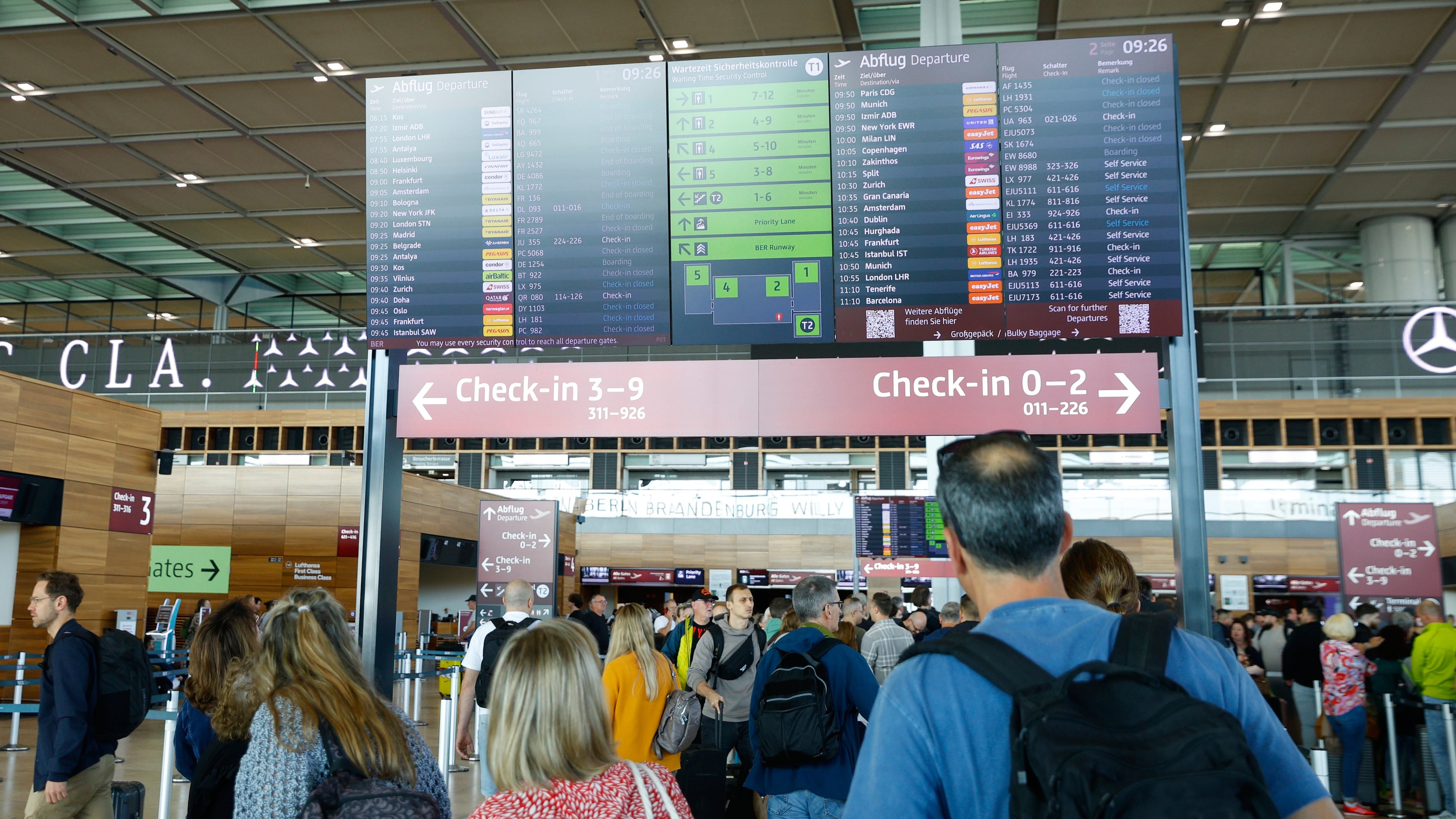 People at BER airport as a cyber attack has caused delays, in Berlin, Germany, Saturday, Sept. 20, 2025. (Carsten Koall/dpa via AP)