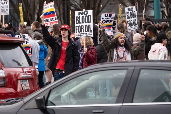 People gather downtown in Atlanta on Saturday, Jan. 3, 2026, to protest against the U.S. military action in Venezuela. (Ben Gray for the AJC)