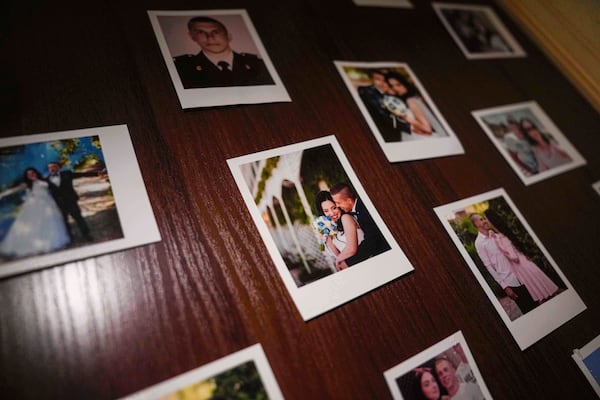 Family photos of Olha Kurtmalaieva and her husband Ruslan are seen at their apartment in Kyiv, Ukraine, on Tuesday, June 17, 2025. (AP Photo/Evgeniy Maloletka)