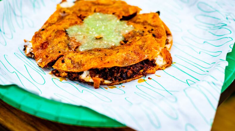 The choriqueso at Supremo Taco is a quesadilla filled with chorizo and cheese, fried to a delectably crispy snap, cut into triangles and drizzled with salsa verde. CONTRIBUTED BY HENRI HOLLIS