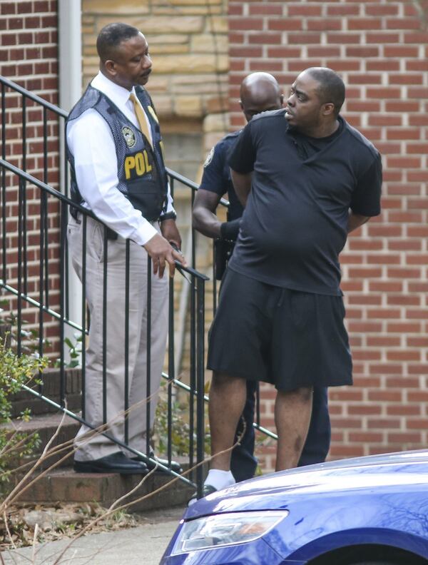 A man identified by police as Cameron Tucker, owner of the dogs involved in the attack, is taken into custody at a home on Chicamauga Avenue not far from where the attacks occurred. JOHN SPINK /JSPINK@AJC.COM
