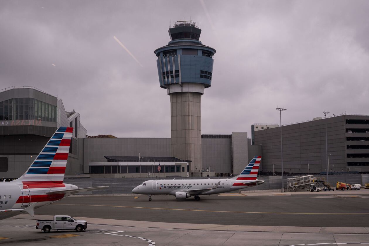 An American Eagle plane moves past the FAA Air Traffic Control tower at LaGuardia Airport (LGA) in the Queens borough of New York, Sunday, Nov. 9, 2025. (AP Photo/Adam Gray)