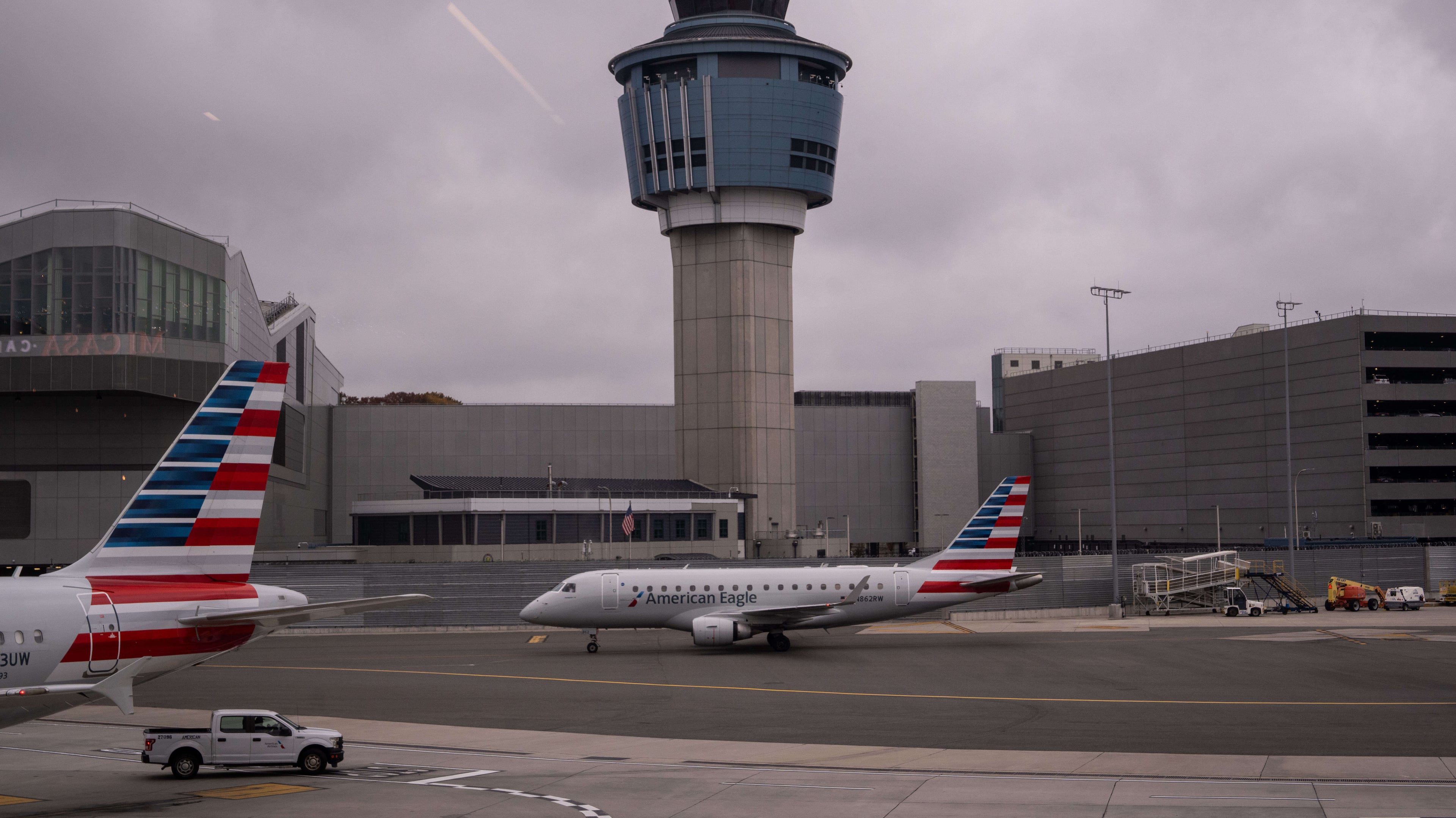 An American Eagle plane moves past the FAA Air Traffic Control tower at LaGuardia Airport (LGA) in the Queens borough of New York, Sunday, Nov. 9, 2025. (AP Photo/Adam Gray)