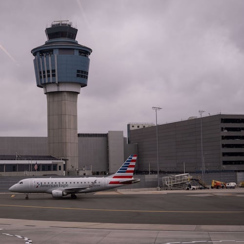 An American Eagle plane moves past the FAA Air Traffic Control tower at LaGuardia Airport (LGA) in the Queens borough of New York, Sunday, Nov. 9, 2025. (AP Photo/Adam Gray)