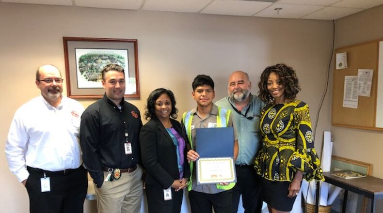 Joining in congratulating Elvin Arias for his heroism are (L-R) Smyrna Fire Chief Roy Acre, Smyrna Assistant Fire Chief Brian Marcos, Smyrna City Administrator Tammi Saddler-Jones, Community Hero Award winner Elvin Arias, Smyrna Public Works Director Frank Martin and Smyrna Ward 3 Councilwoman Maryline Blackburn. Courtesy of Smyrna