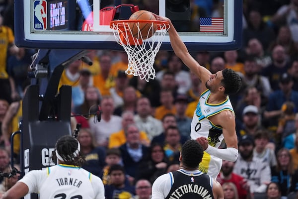 Indiana Pacers guard Tyrese Haliburton (0) gets a basket on a dunk against the Milwaukee Bucks during the first half of a first-round NBA basketball playoff game in Indianapolis, Tuesday, April 22, 2025. (AP Photo/Michael Conroy)