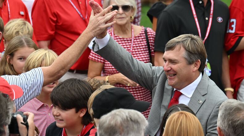 Georgia's head coach Kirby Smart is surrounded by fans as players and coaching staff participate in the Dawg Walk before their game against South Carolina in an NCAA football game at Sanford Stadium, Saturday, September 16, 2023, in Athens. (Hyosub Shin / Hyosub.Shin@ajc.com)