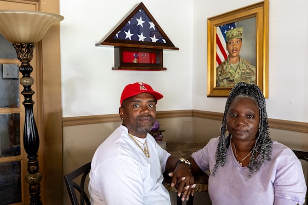 Shawn Sanders (left) and Oneida Oliver-Sanders, parents of Army Reserve Sgt. Kennedy L. Sanders, pose for a portrait at their home in Waycross on May 16, 2025. Kennedy Sanders was killed last year in a drone strike in Jordan. (Arvin Temkar/AJC)