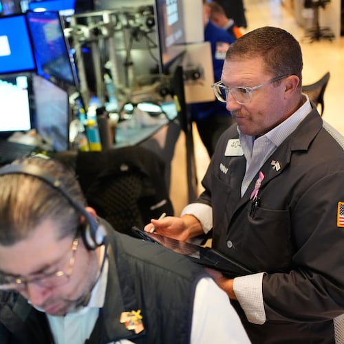 Ryan Falvey, right, works on the floor at the New York Stock Exchange in New York, Wednesday, Oct. 29, 2025. (AP Photo/Seth Wenig)