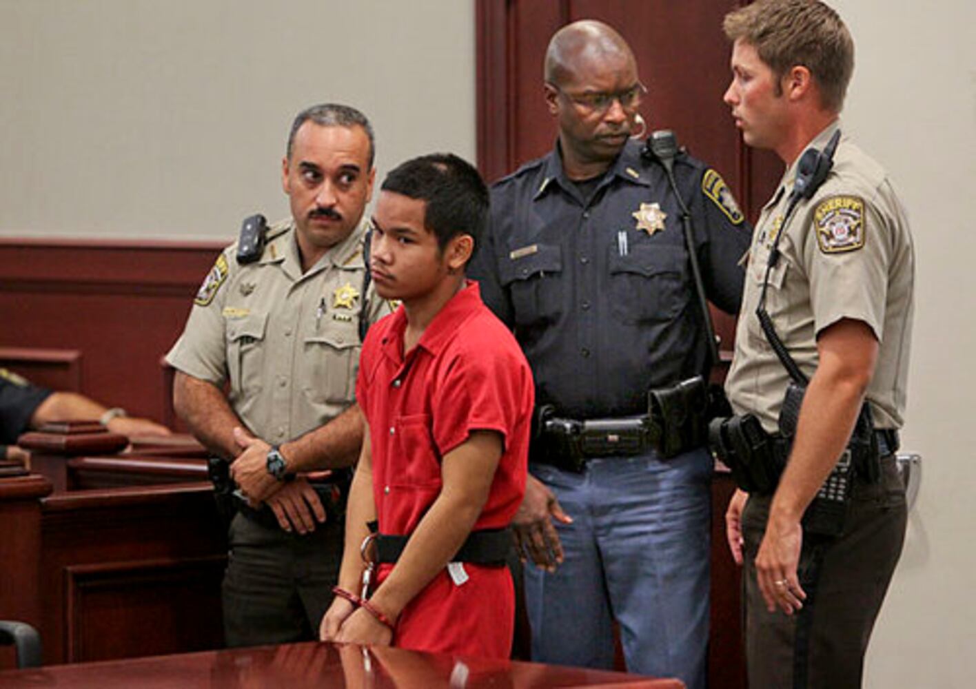 Teen in court, accused of killing cop