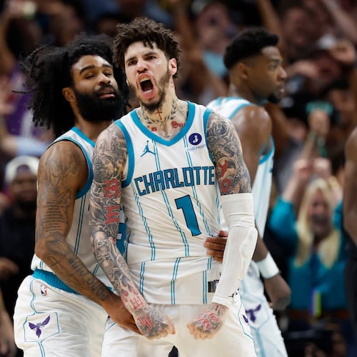 Charlotte Hornets guard LaMelo Ball (1) celebrates with guard Coby White after scoring against the Miami Heat during the second half of an NBA play-in tournament basketball game in Charlotte, N.C., Tuesday, April 14, 2026. (AP Photo/Nell Redmond)