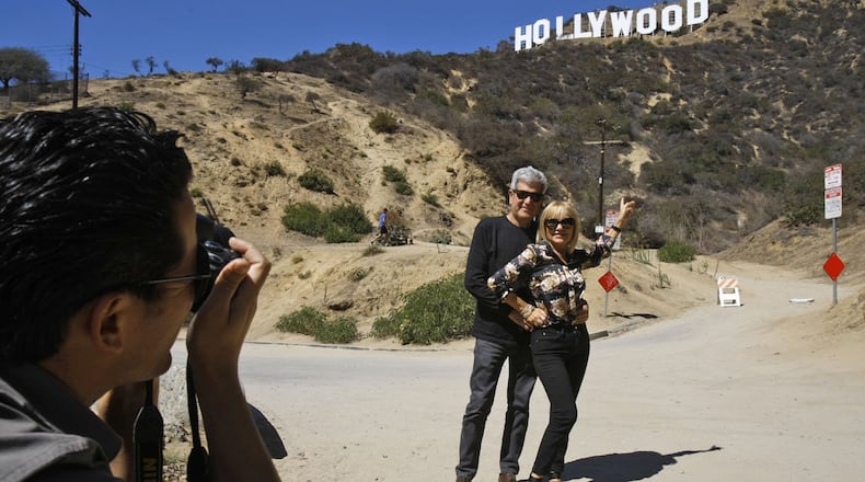 Silvestre Llobet and his wife, Elena Domenech, are photographed by their son, Alejandro Llobet, left, under the Hollywood sign on September 26, 2013, in the Beachwood Canyon area of Los Angeles. (Gary Friedman/Los Angeles Times/TNS)