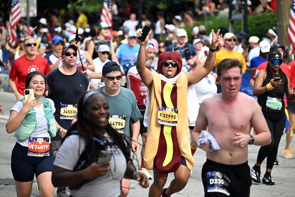 While standard runners’ gear was the norm, a few decided to sweat it out in costume during Saturday’s Peachtree Road Race. (Hyosub Shin/AJC)