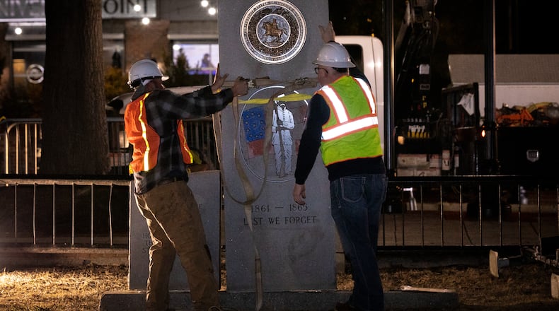 A crew works to remove a Confederate monument from its place on the grounds of the Gwinnett Historic Courthouse in Lawrenceville, Ga., on Thursday, Feb. 4, 2021. The Gwinnett County Board of Commissioners voted unanimously on January 19 to remove the monument, overturning the decision of their predecessors from almost three decades prior. In 1993, county commissioners gave permission for the monument to be installed at the request of the United Daughters of the Confederacy. (Casey Sykes for The Atlanta Journal-Constitution)