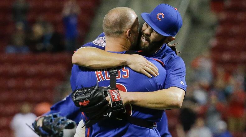 Ex-Braves catcher David Ross (left) hugs the Cubs' Jake Arrieta after they completed a no-hitter against the Reds Thursday night. AP photo