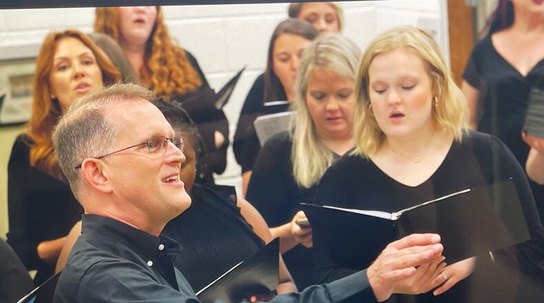 Longtime Cartersville High School chorus teacher Jim Stanley leads a group of former students during a concert on Saturday, May 13 in honor of his retirement next week. Courtesy photo.