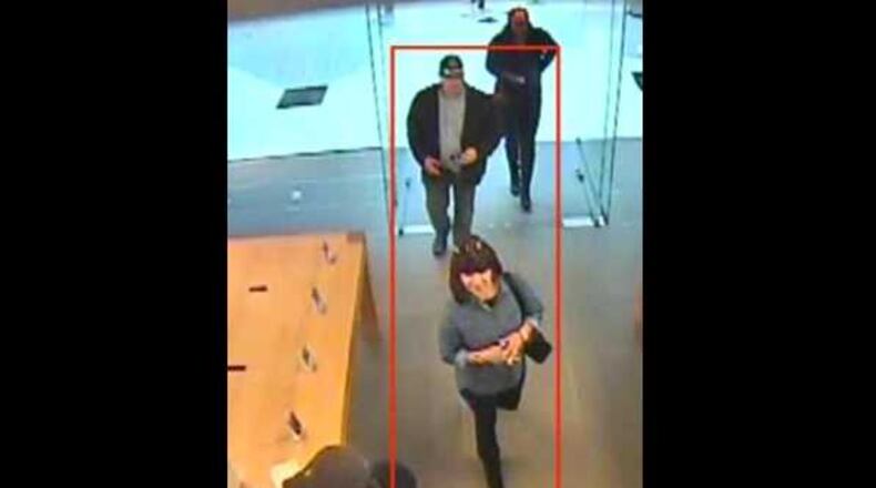 Police in Alpharetta are searching for two suspects who stole a woman's wallet and escaped in a minivan. // Alpharetta Department of Public Safety