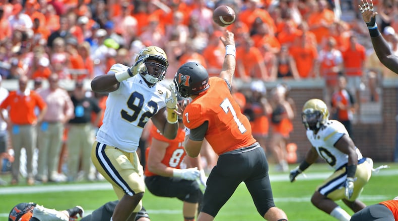 Mercer Bears quarterback John Russ (7) gets off a pass under pressure from Georgia Tech Yellow Jackets defensive lineman Francis Kallon (92) in the first half at Bobby Dodd Stadium on Saturday, September 10, 2016. HYOSUB SHIN / HSHIN@AJC.COM
