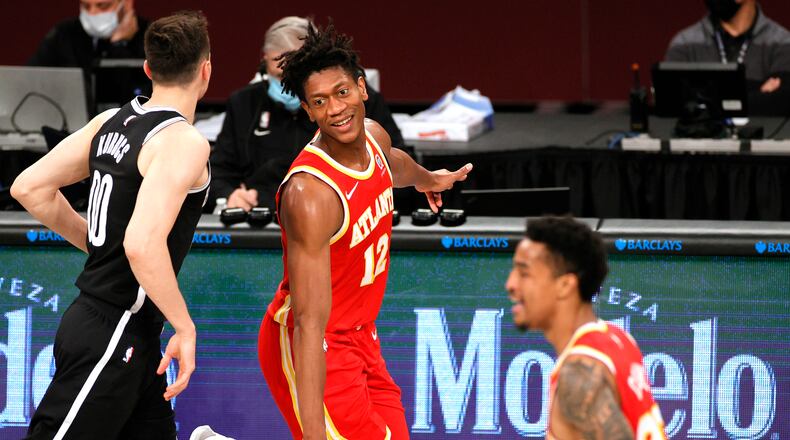 The Atlanta Hawks' De'Andre Hunter (12) reacts during the second half against the Brooklyn Nets at Barclays Center in New York on Friday, Jan. 1, 2021. The Hawks won, 114-96. (Sarah Stier/Getty Images/TNS)