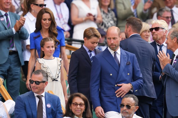 Britain's Prince William, right, Kate, Princess of Wales, Prince George and Princess Charlotte arrive at the Royal Box to watch Jannik Sinner of Italy and Carlos Alcaraz of Spain during their men's singles final match at the Wimbledon Tennis Championships in London, Sunday, July 13, 2025.(AP Photo/Kirsty Wigglesworth)