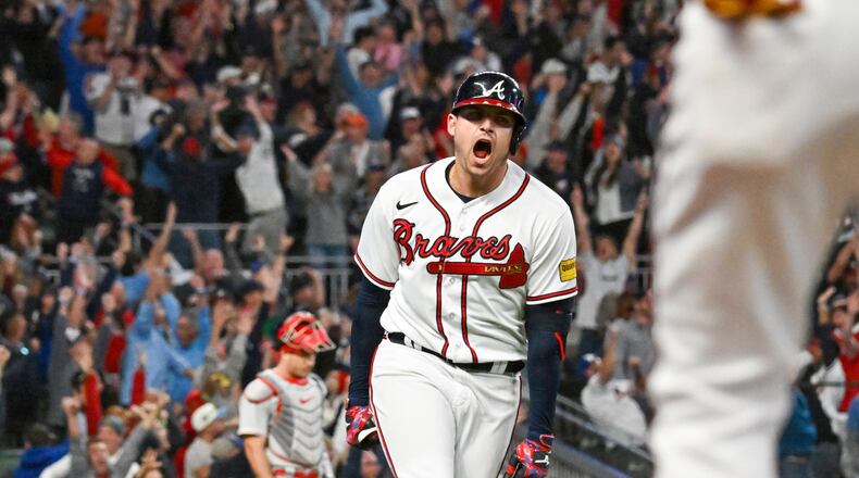 Atlanta Braves’ Austin Riley (27) celebrates a two-run home run against the Philadelphia Phillies during the eighth inning of NLDS Game 2 in Atlanta on Monday, Oct. 9, 2023.   (Hyosub Shin / Hyosub.Shin@ajc.com)