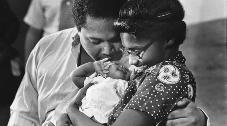 Bobby and Sandra Alexander had a kiss for their returned baby Shanta at a Grady Hospital press conference on Sept. 16, 1981. “Things turned out pretty well,” the mother said recently. “After everything we went through together, I can’t imagine being without her. She’s still my baby. I didn’t want to think about life without her.” (Lanna Swindler / AJC Archive at GSU Library AJCP339-175d)