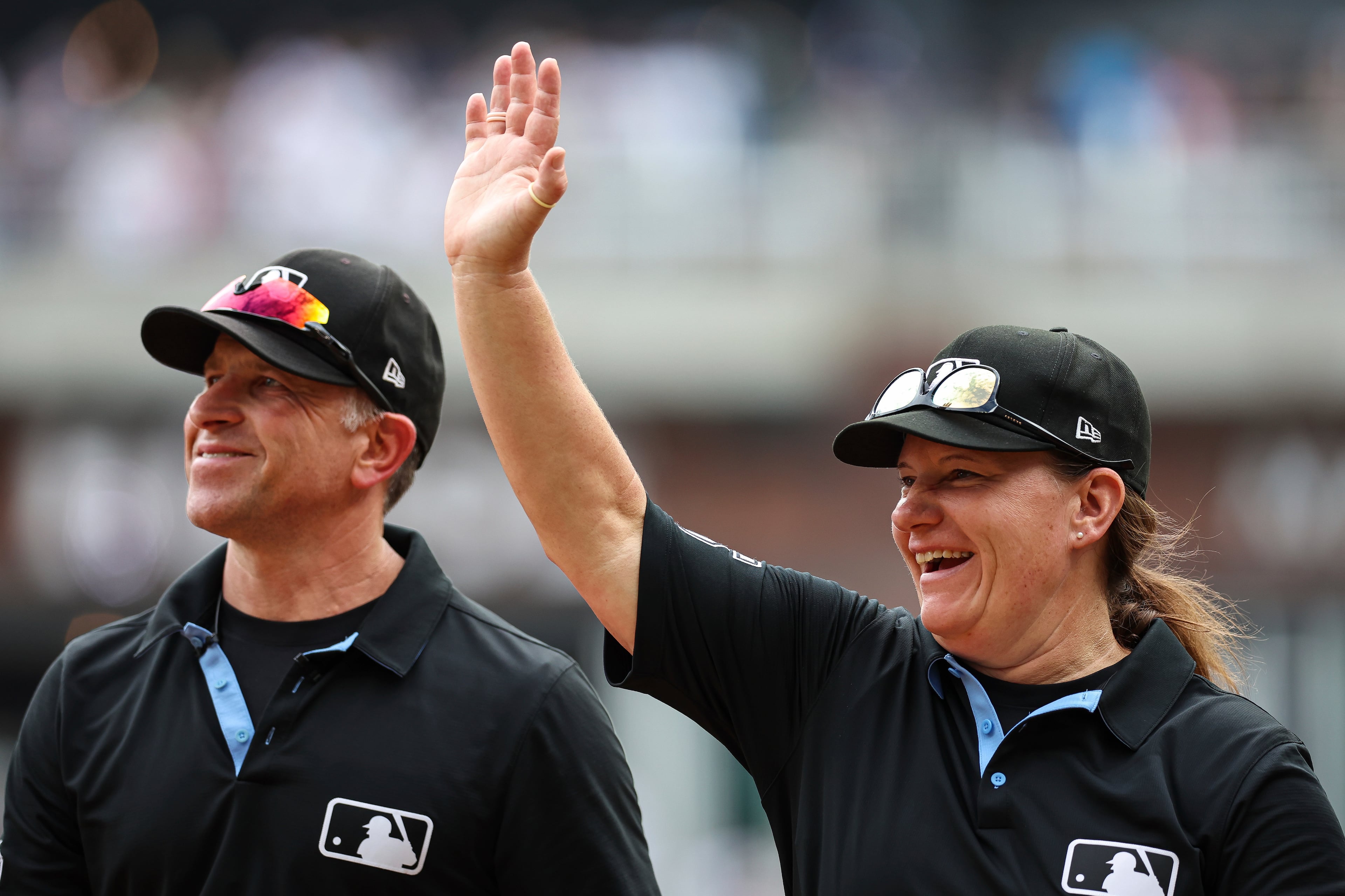 Umpire Jen Pawol (right) waves to the crowd after Game 1 of Saturday's doubleheader at Truist Park.