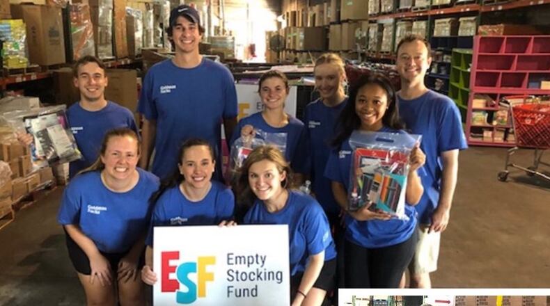 The Empty Stocking Fund plans to distribute school supplies to 30,000 Atlanta-area students this year. Shown here volunteers from the Goldman Sachs Atlanta office recently helped assemble Student Supply Kits. (Courtesy Empty Stocking Fund)