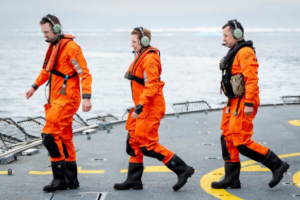 Denmark's Prime Minister Mette Frederiksen, center, Greenlands acting head of government Múte Bourup Egede, right, and newly elected head of government, Jens-Frederik Nielsen, walk after a trip with a Danish Navy Sea Hawk helicopter from the Danish Navy inspection ship Vaedderen, in the waters around Nuuk, Greenland, Thursday, April 3, 2025. (Mads Claus Rasmussen/Ritzau Scanpix via AP)