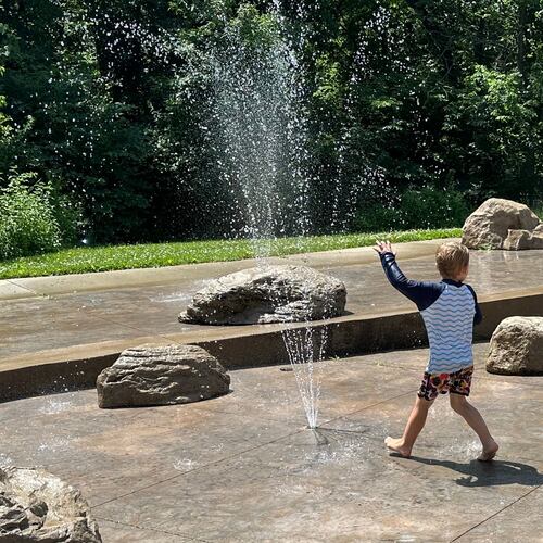 Children play at a water sprayground in Des Moines, Iowa, Monday, June 29, 2026. (AP Photo/Hannah Fingerhut)