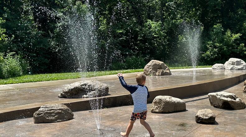 Children play at a water sprayground in Des Moines, Iowa, Monday, June 29, 2026. (AP Photo/Hannah Fingerhut)