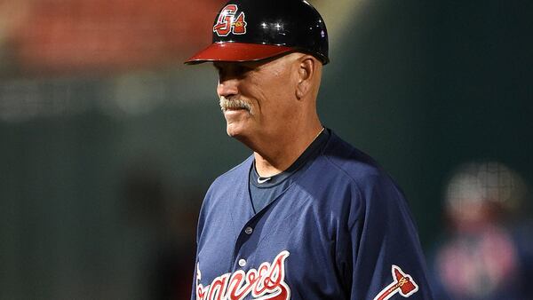 Gwinnett Braves manager Brian Snitker (4) walks to the dugout in between innings during a game against the Buffalo Bisons on May 13, 2014 at Coca-Cola Field in Buffalo, New  York.  Gwinnett defeated Buffalo 3-2.  (Mike Janes/Four Seam Images via AP Images)