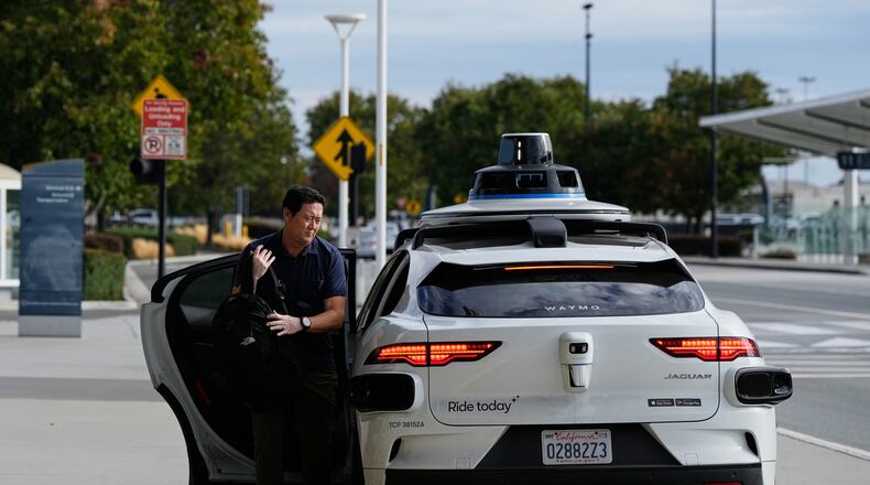 Dan Rowan exits a Waymo vehicle after arriving at San Jose Mineta International Airport, Wednesday, Nov. 12, 2025, in San Jose, Calif. (AP Photo/Godofredo A. Vásquez)