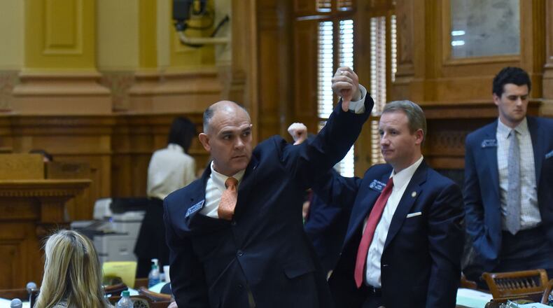 March 7, 2019, Atlanta -- Sen. Bruce Thompson, R-White, gives a sign to supporters to vote down an amendment to Senate Bill 163, his bill giving home schooled students access to public school sports. The bill passed without the amendment.