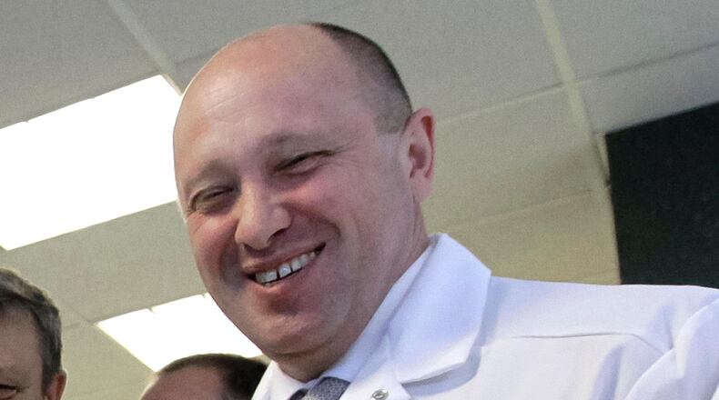FILE - In this Monday, Sept. 20, 2010, file photo, businessman Yevgeny Prigozhin smiles as he shows Russian President Vladimir Putin around his 'Konkord' factory which produces school meals outside St. Petersburg, Russia. One of those indicted in the Russia probe is a businessman with ties to Russian President Vladimir Putin. Prigozhin is an entrepreneur from St. Petersburg who Ãs been dubbed "Putin's chef" by Russian media. His restaurants and catering businesses have hosted the Kremlin leader's dinners with foreign dignitaries. (Alexei Druzhinin, Sputnik, Kremlin Pool Photo via AP, File)