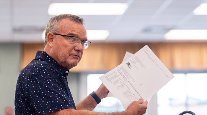 Cobb County resident Eugene Williams holds papers related to his challenge against the registrations of 2,472 voters during a Cobb County Board of Elections and Registration meeting Saturday at the Cobb County Safety Village in Marietta. Seeger Gray/AJC