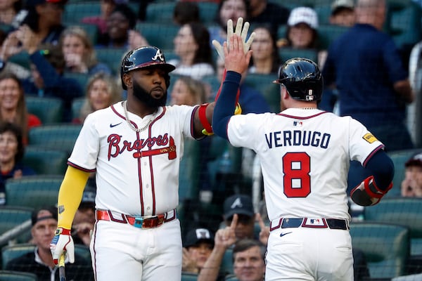 Atlanta Braves' Alex Verdugo (8) celebrates with Marcell Ozuna, left, after scoring during the third inning of a baseball game against the Cincinnati Reds, Monday, May 5, 2025, in Atlanta. (AP Photo/Butch Dill)