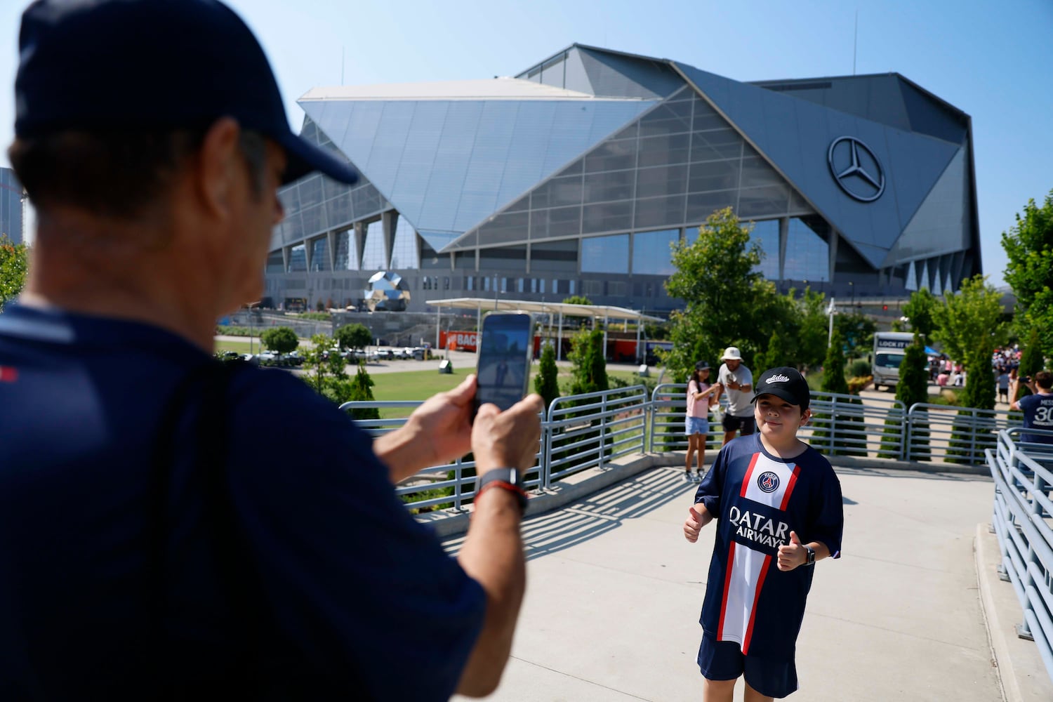 Raúl Romero from Buford takes a cellphone photo of Jerónimo Bonilla as they arrive at the Mercedes-Benz Stadium prior to the round of 16 soccer match between Paris Saint-Germain FC and Inter Miami in Atlanta, Georgia, on Sunday, June 29, 2025.
(Miguel Martinez/ AJC)