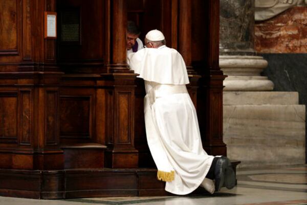 FILE - Pope Francis kneels before a priest to confess, during a penitential liturgy in St. Peter's Basilica at the Vatican, Friday, March 17, 2017. (AP Photo/Andrew Medichini, Pool, File)