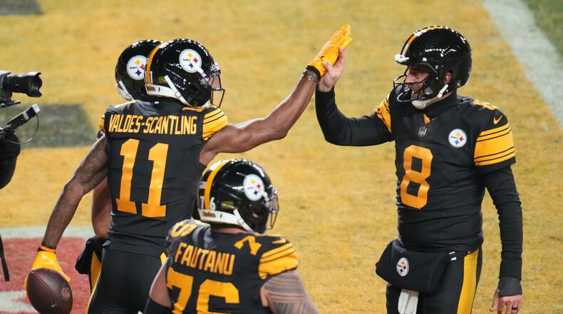 Pittsburgh Steelers' Marquez Valdes-Scantling (11), Aaron Rodgers (8) and Troy Fautanu (76) celebrate after Marquez Valdes-Scantling caught a touchdown pass in the second half of an NFL football game against the Miami Dolphins in Pittsburgh, Monday, Dec. 15, 2025. (AP Photo/Gene J. Puskar)