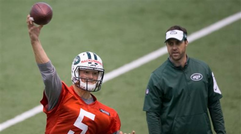 Former Penn State quarterback Christian Hackenberg throws at New York Jets rookie minicamp as quarterbacks coach Kevin Patullo looks on, in Florham Park, N.J., Friday, May 6, 2016. (Joe Hermitt/PennLive.com via AP) MANDATORY CREDIT; MAGS OUT
