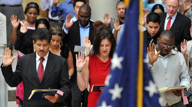 Candidates for citizenship recite the Oath of Allegiance during a naturalization ceremony at the Georgia Capitol on Sept. 17, 2010. Brant Sanderlin/bsanderlin@ajc.com