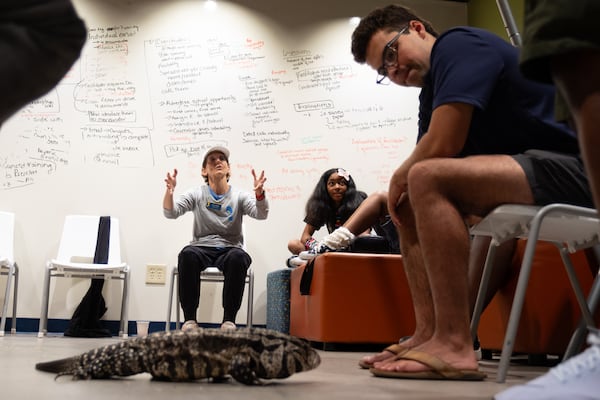 Lisa Aman, executive director of Kate’s Club, talks with a group during a reptile experience at a clubhouse gathering in Brookhaven. (Ben Gray for the AJC)