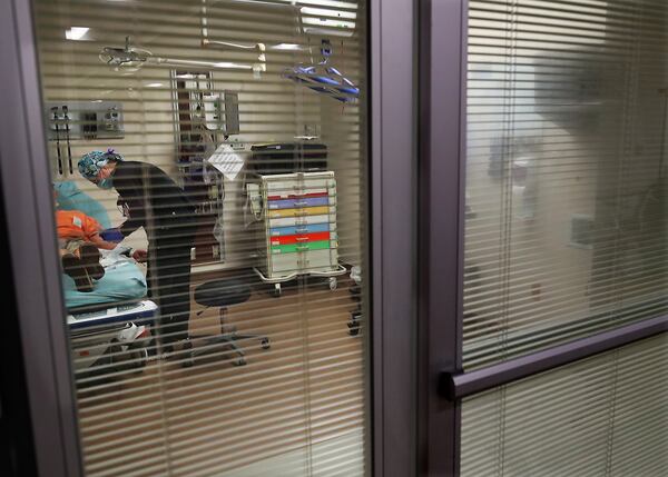 Nurse Carey Mullis works with a COVID patient just after his arrival by ambulance inside an emergency room at the Colquitt Regional Medical Center. The fourth wave of COVID is causing many nurses with long experience to consider quitting and moving to calmer jobs. (Curtis Compton / Curtis.Compton@ajc.com)