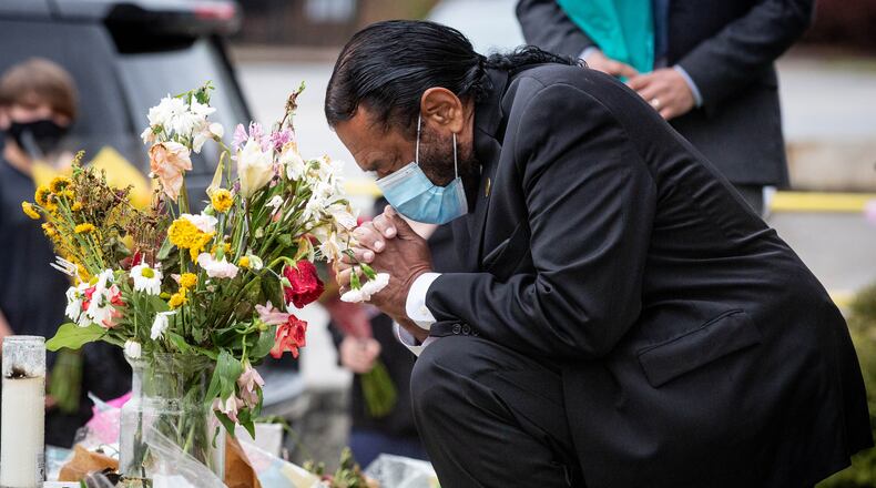 U.S. Rep. Al Green, D-Texas, of the Congressional Asian Pacific American Caucus, takes a moment to pray after laying flowers at Gold Spa in Atlanta.